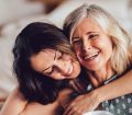senior woman and her daughter embrace