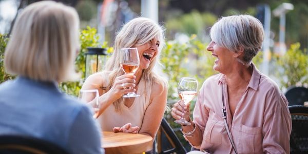 group of senior friends drinking wine