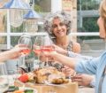 Over 50s drinking wine at dinnertable
