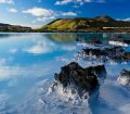 Blue water overlooked by mountains