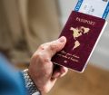 Man's hand holding passport