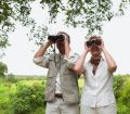 senior couple looking at landscape with binoculars