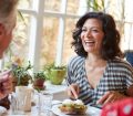 two friends laughing over lunch