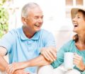 senior couple drinking coffee in the sunshine
