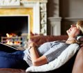 woman relaxing on sofa with headphones