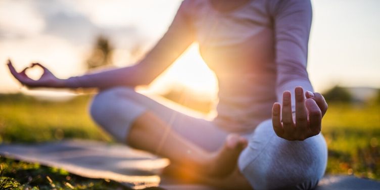 woman meditating outdoors