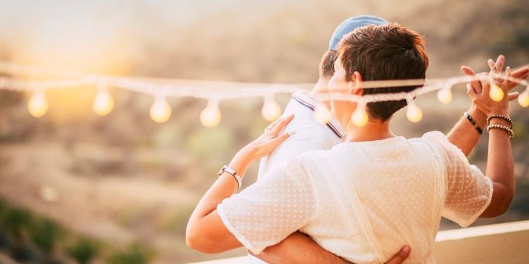 couple dancing outdoors under lights