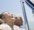 Silver Migration: Happy Mature Travellers Driving In Car