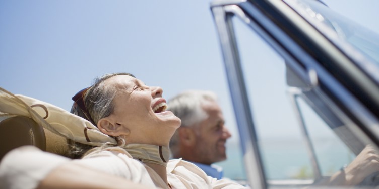 Silver Migration: Happy Mature Travellers Driving In Car