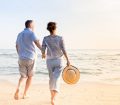 mature couple walking on the beach together