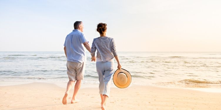mature couple walking on the beach together