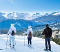 family skiing in the mountains