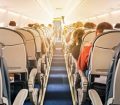 Aircraft cabin with rows of seats, view down aisle