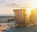 Couple on beach chairs at sunset