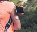 Person checking glucose levels with flash glucose monitor