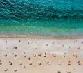 an image of a beach where visitors are practicing social distancing