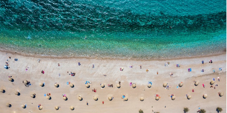an image of a beach where visitors are practicing social distancing
