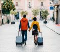 an image of a couple walking together on holiday wearing amber and red jackets