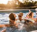 Multi-generation family playing in swimming pool